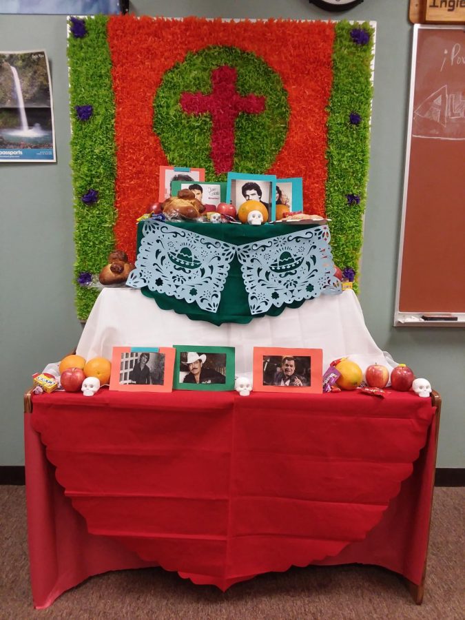 The Day of the Dead altar that Spanish Club members designed. It is decorated with tissue paper, photos of famous Central American singers, colored tablecloths, and many more.