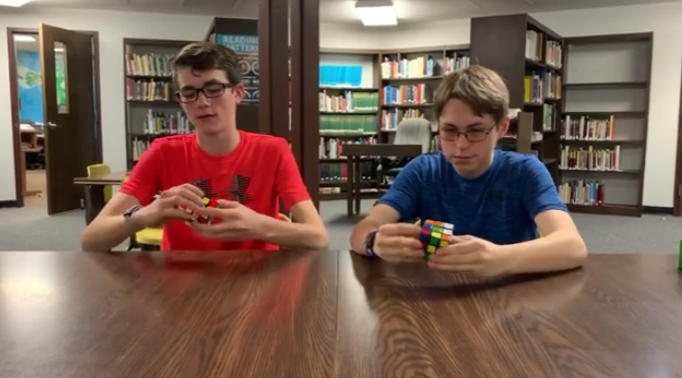 Greyson Pembleton and Matthew Redden race to solve a Rubiks Cube first.