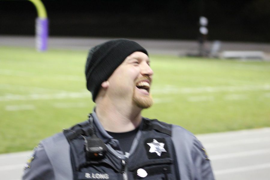 Officer+Long+laughs+as+the+student+section+talks+to+him+during+the+Hillsboro+game.+